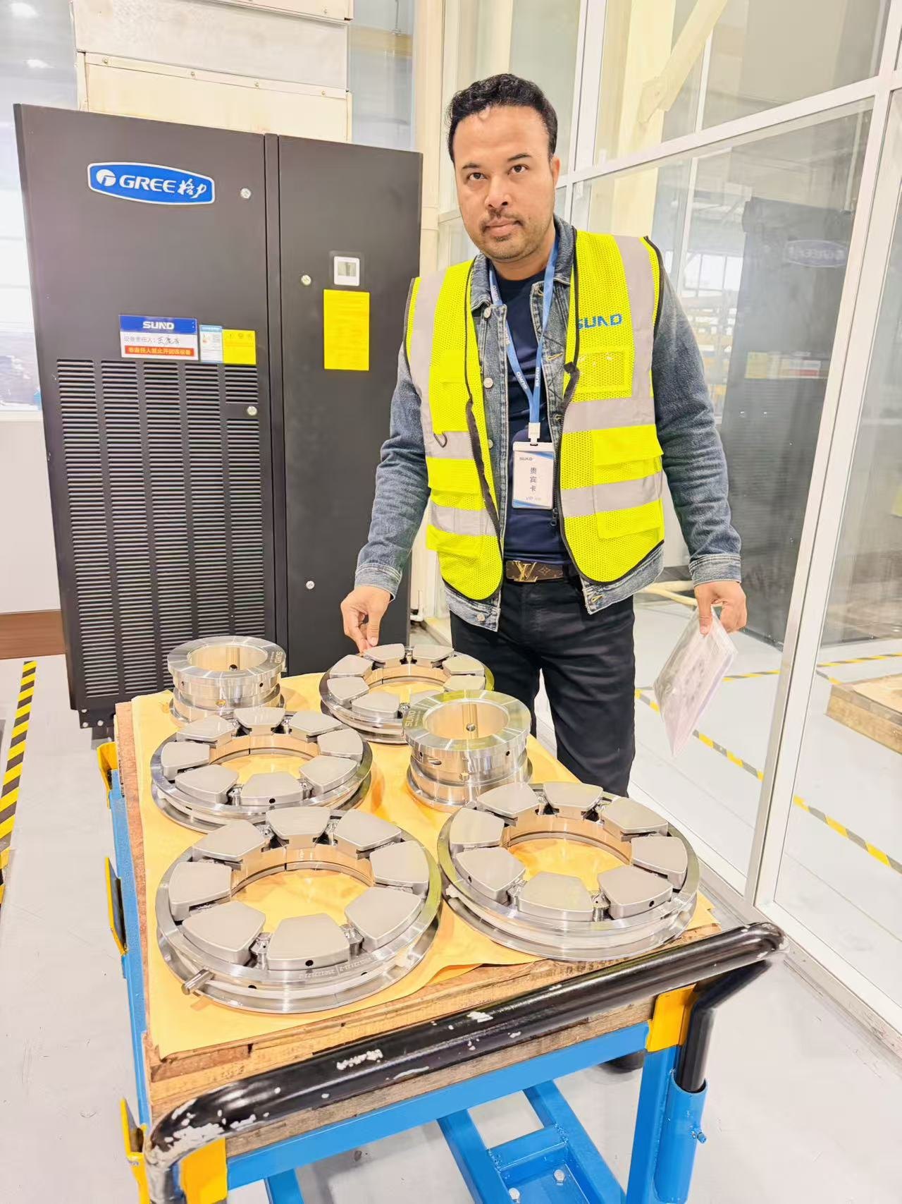 Swiftpath representative inspecting thrust bearing pad assemblies at a Chinese OEM for a CCPP project
